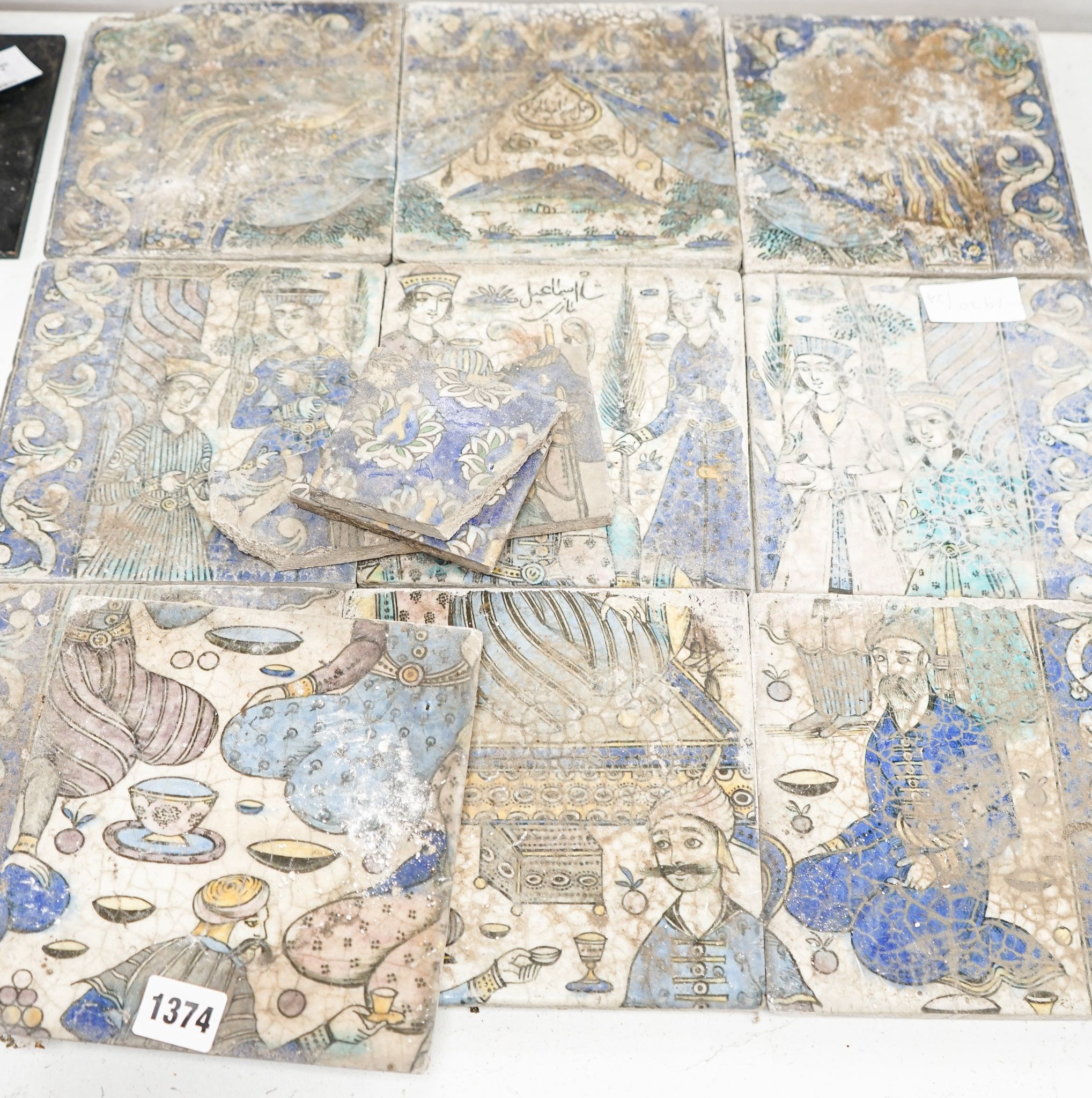 A Persian fritware tile panel, late 19th/early 20th century, incomplete, 55cm wide and another tile fragment